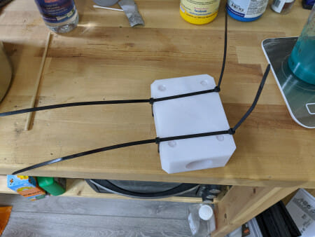 Secure the two sides together with cable ties. You can use whatever method you want to hold them together, but it has to be pretty tight, and also keep in mind that it will have to fit into the vacuum chamber later if you are planning on degassing, so no huge clamp setups.