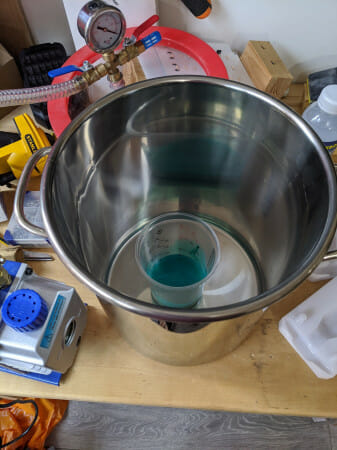 Place the mixed epoxy into the chamber, close it, close the re-pressurising valve, and turn the vacuum pump on.